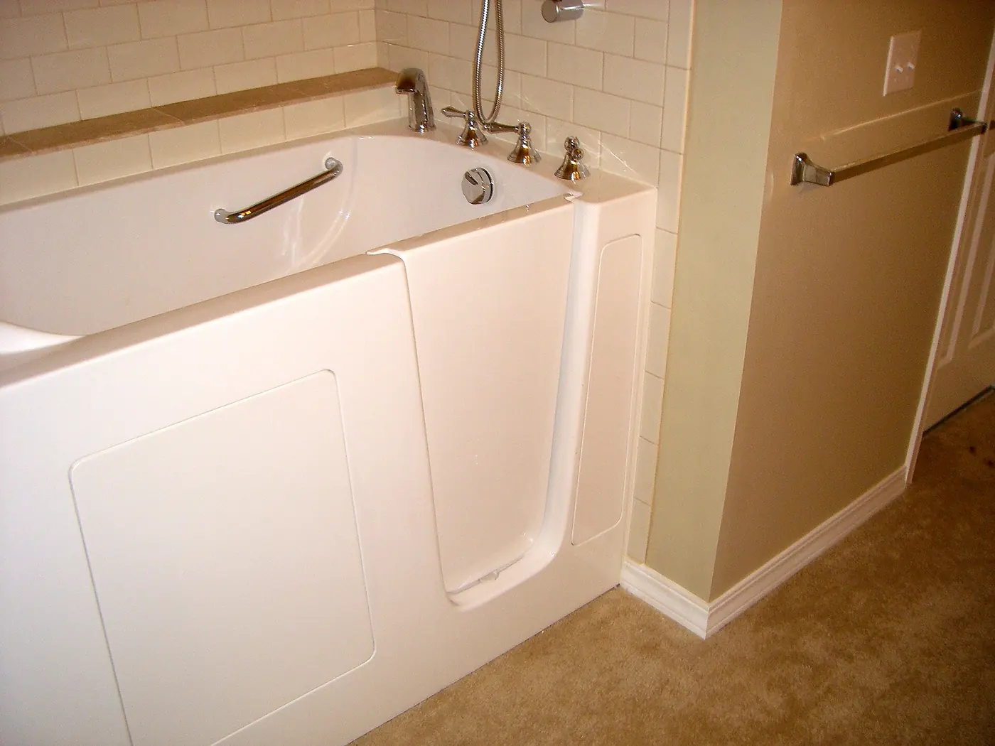A walk-in bath with a built-in door and grab rails
