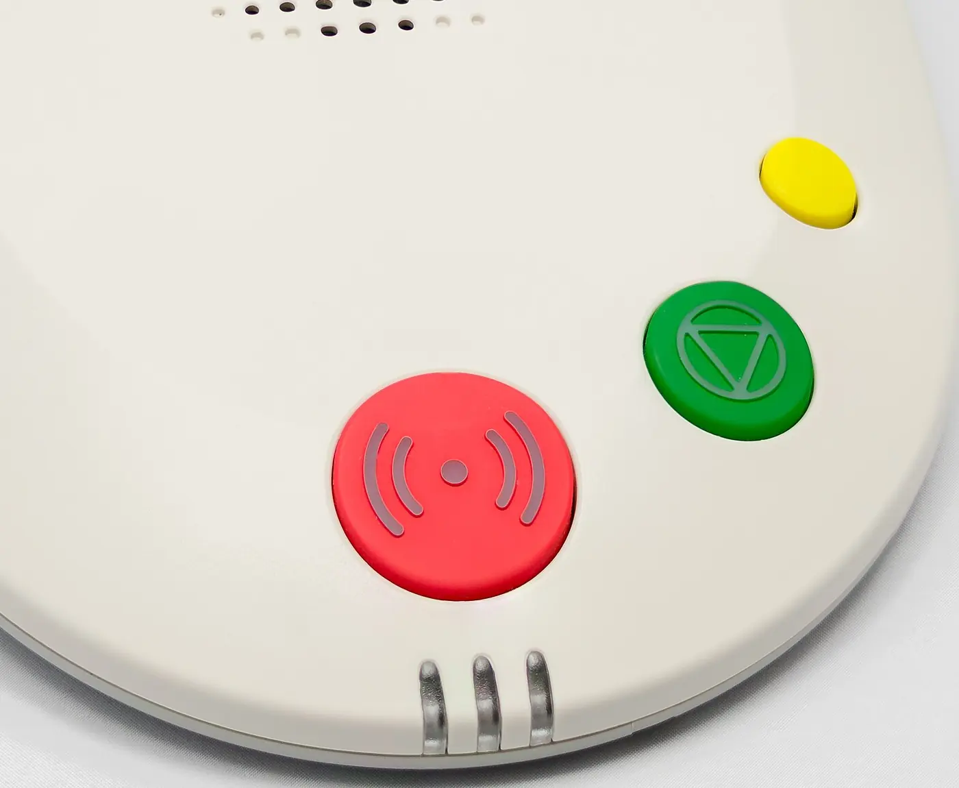 A personal alarm base unit with a large red call button